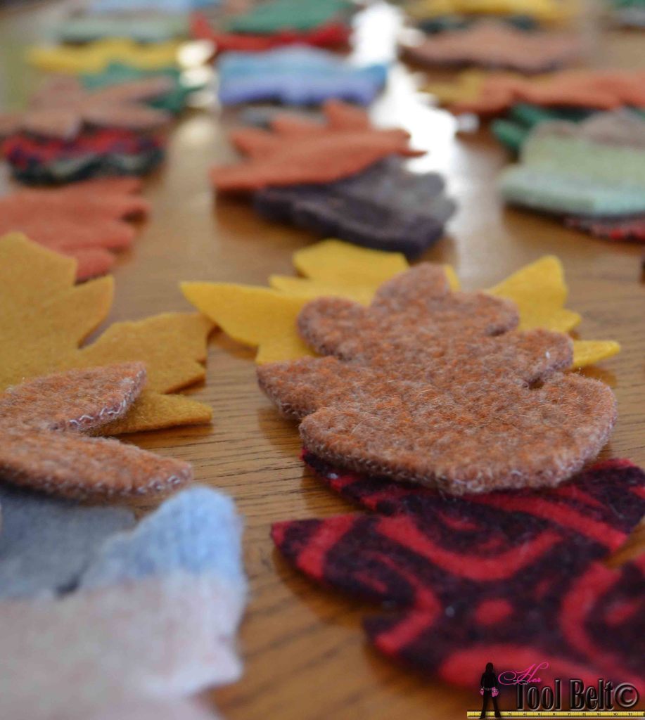 Super easy fall garland from recycled sweaters and felt. #falldecorations #fallcrafts #hertoolbelt