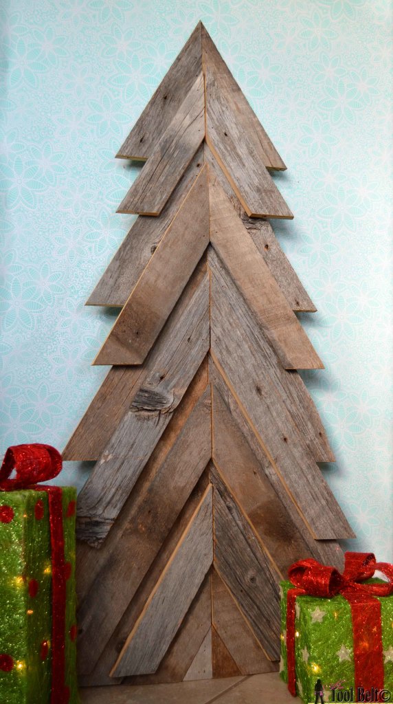 An easy way to add natural elements into your Christmas decor, build a rustic Christmas Tree from pallets or barn wood.