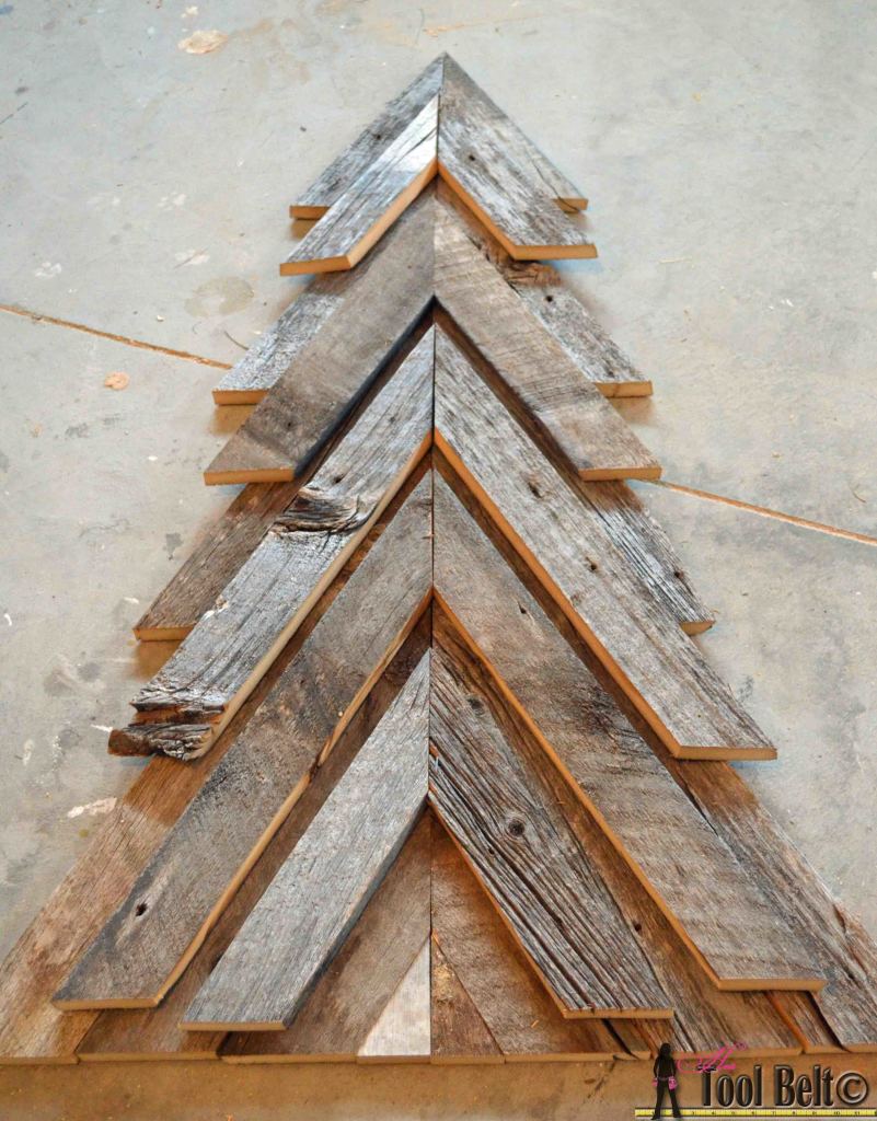 An easy way to add natural elements into your Christmas decor, build a rustic Christmas Tree from pallets or barn wood.