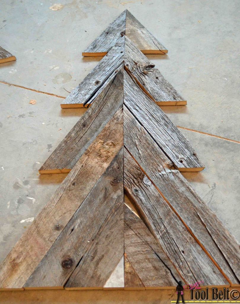 An easy way to add natural elements into your Christmas decor, build a rustic Christmas Tree from pallets or barn wood.