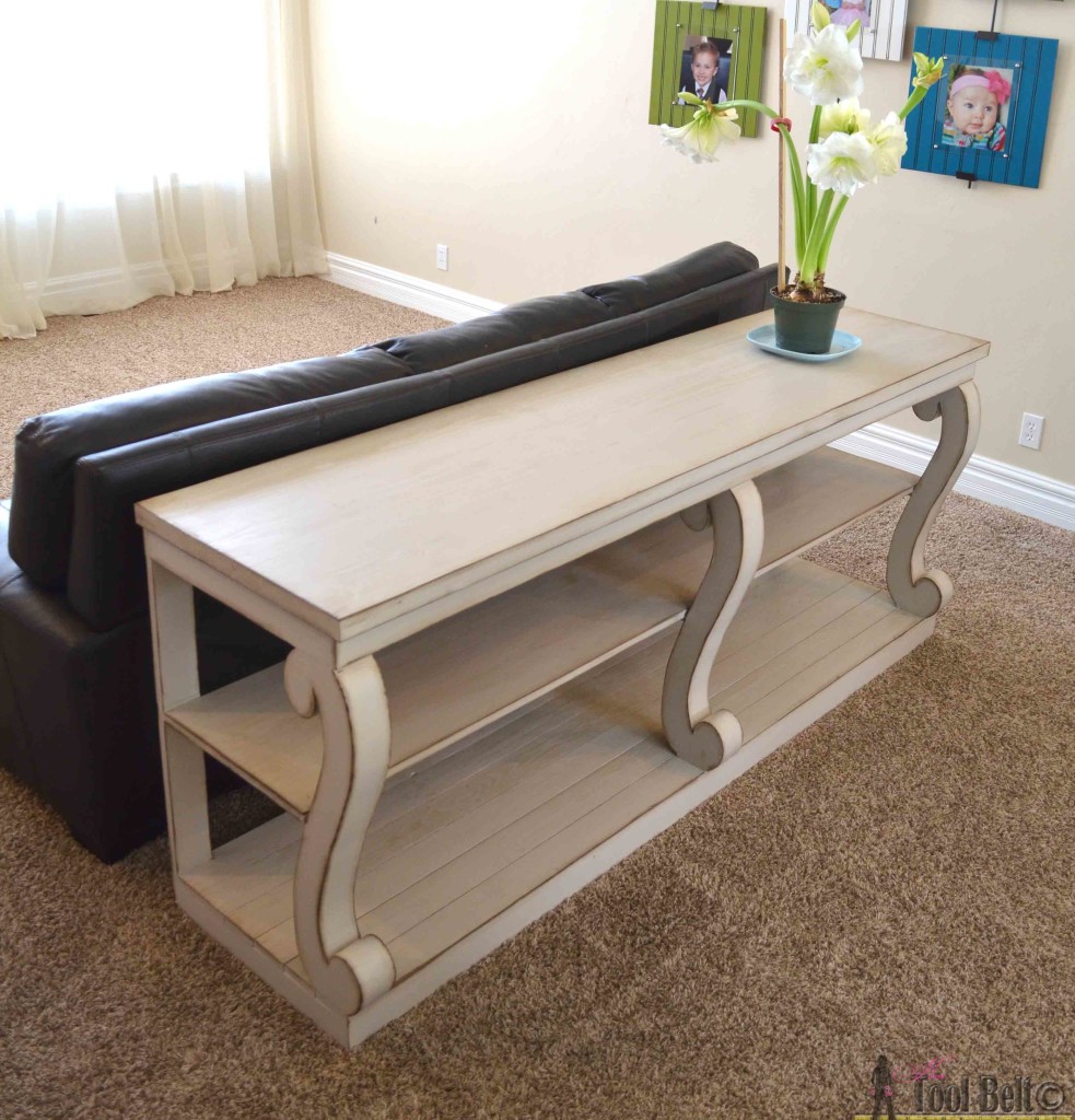 Build a console table with awesome scroll legs, definitely a statement piece! Free woodworking plans.