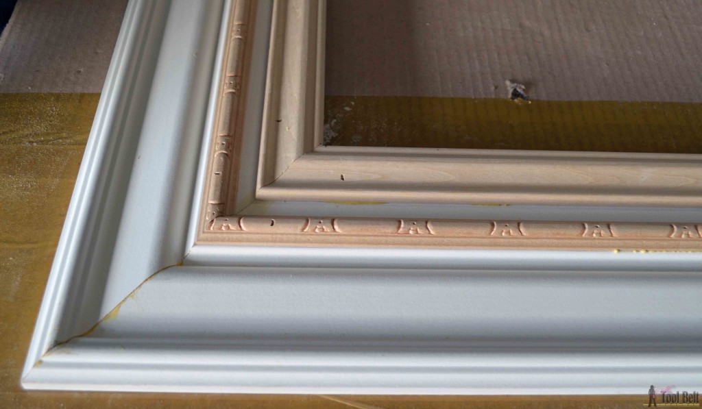 Build a DIY custom picture frame using moulding from the hardware store, so much cheaper than a framing store. 