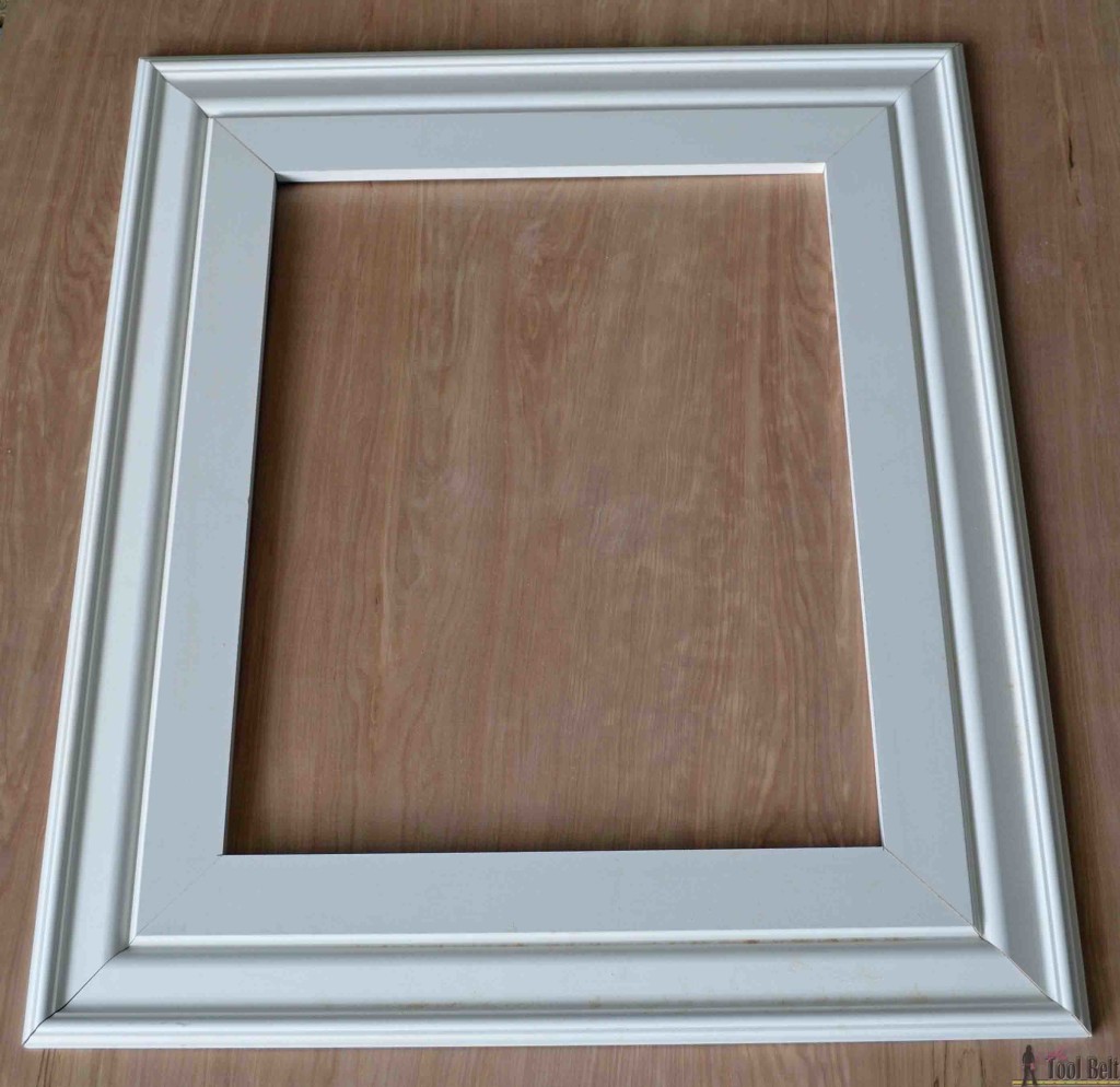 Build a DIY custom picture frame using moulding from the hardware store, so much cheaper than a framing store. 