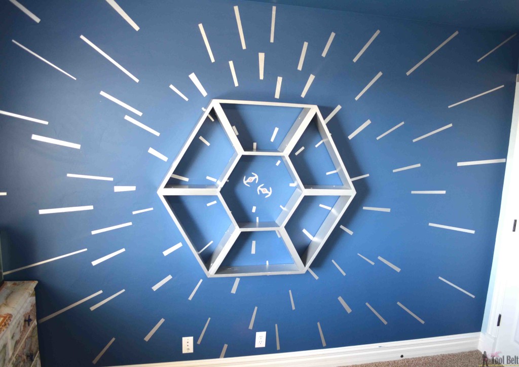 An awesome Star Wars bedroom with a hyperspace focal wall and fighter cockpit Star Wars Shelf. The boys are going to love this!!!