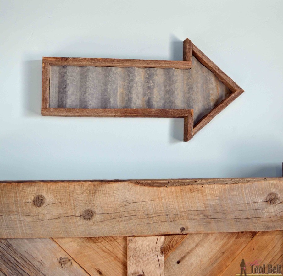 Build an easy industrial and rustic arrow with reclaimed wood and old corrugated tin with these free plans.