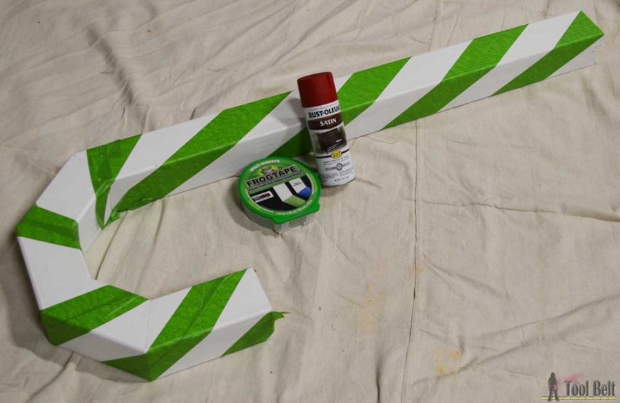 This is a perfect way to hang my Christmas stockings without a mantel! Free plans to build a DIY holiday Candy Cane stocking holder from a simple wood 4x4 post.