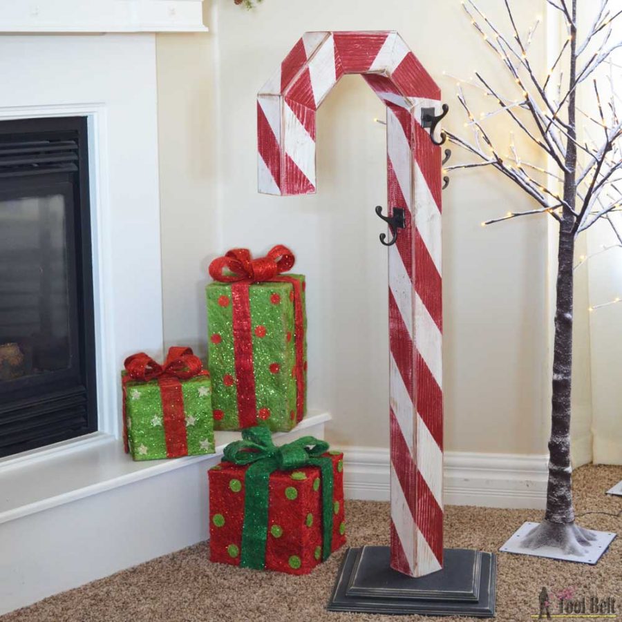 This is a perfect way to hang my Christmas stockings without a mantel! Free plans to build a DIY holiday Candy Cane stocking holder from a simple wood 4x4 post.