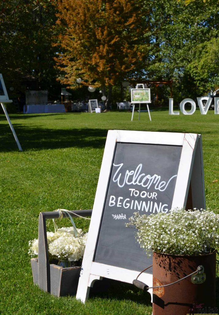 Wedding entrance 'Welcome to Our beginning" with a DIY chalkboard easel.