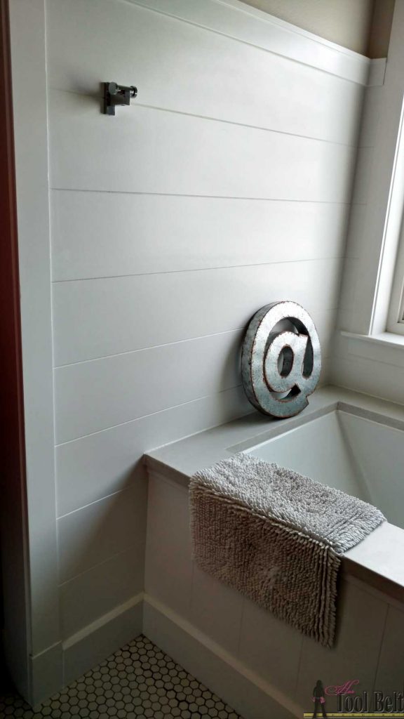 Karilyn's bathroom - faux shiplap wall. Love the look of a shiplap wall but don't want the gaps between the planks. Problem solved, route grooves in a plywood sheet for the shiplap 'planked' wall look! Set by step guide and tips.