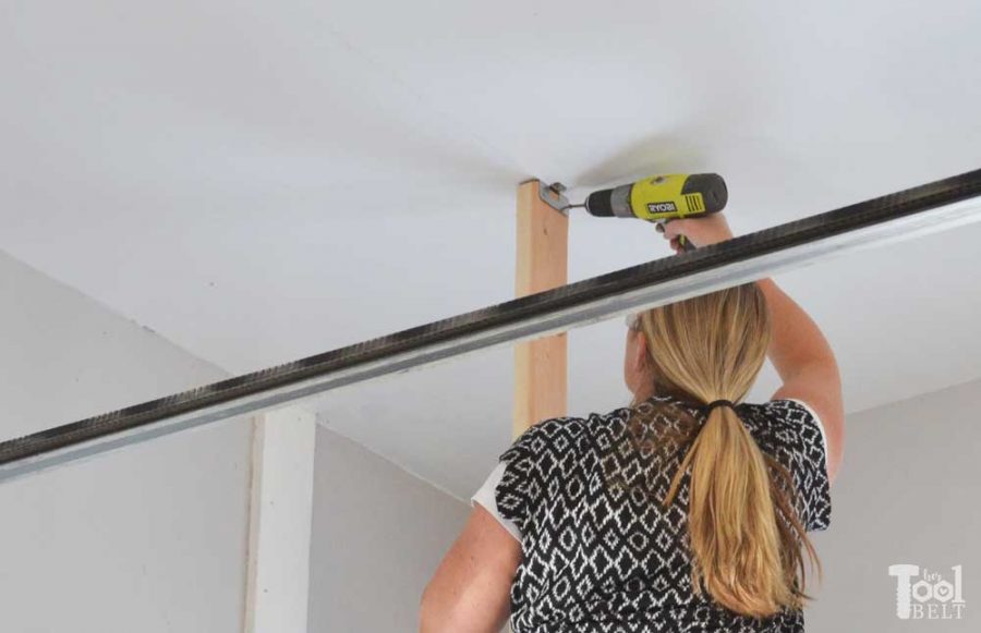 Take advantage of that empty space above your garage door. Build an overhead garage storage shelf perfect for seasonal storage items. 