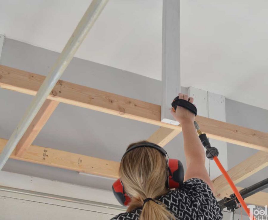 Take advantage of that empty space above your garage door. Build an overhead garage storage shelf perfect for seasonal storage items. 