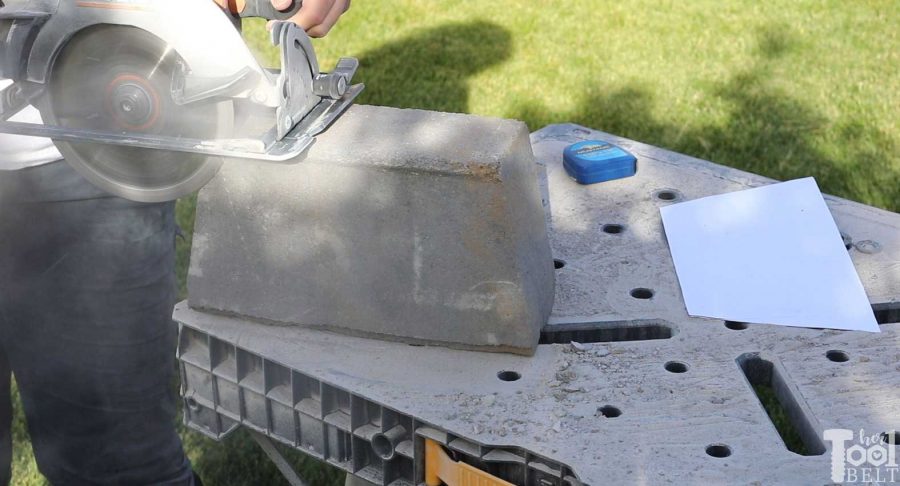 cutting the blocks to fit with circular saw and masonry blade - How to build a DIY backyard firepit with wall blocks from Home Depot. 