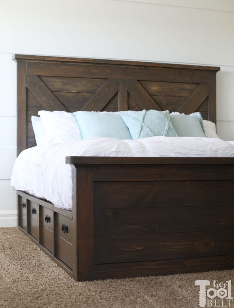 Build a barn door farmhouse bed with X headboard. Free king size bed building plans on hertoolbelt.com.