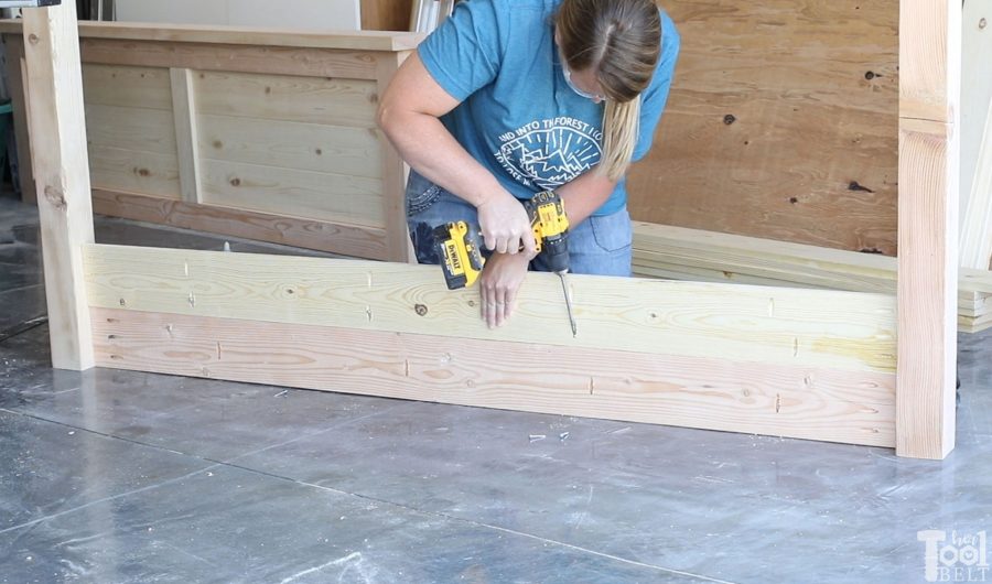 Build a barn door farmhouse bed with X headboard. Free queen size bed building plans on hertoolbelt.com.