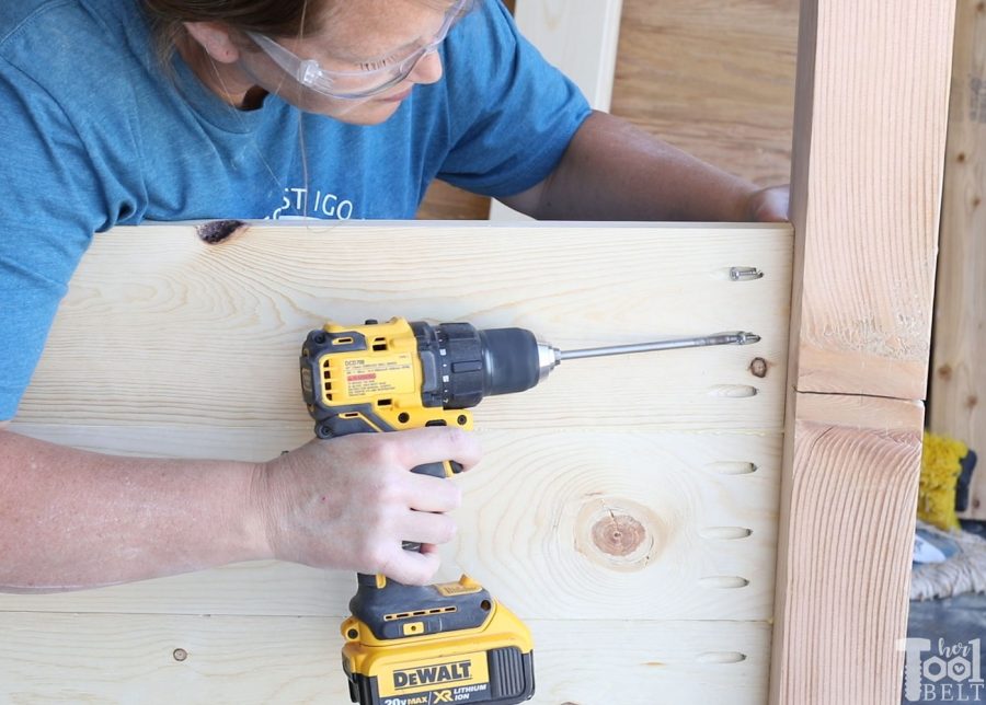 Build a barn door farmhouse bed with X headboard. Free queen size bed building plans on hertoolbelt.com.