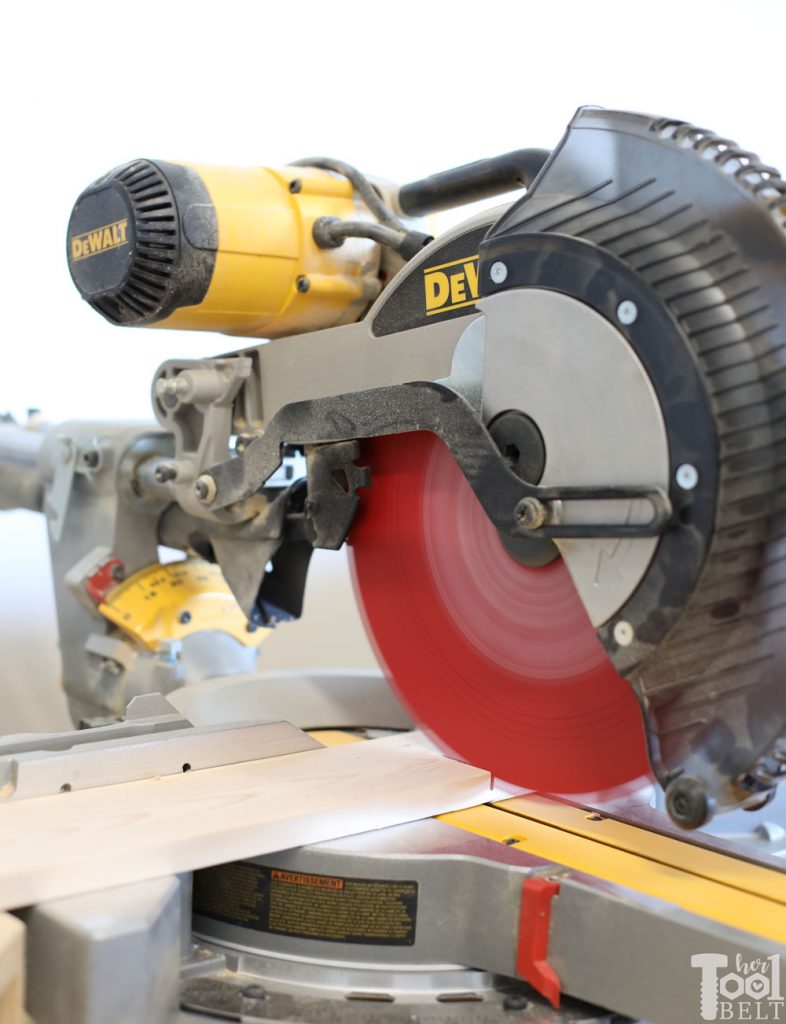 Using miter saw to cut window shadow box shelf boards.