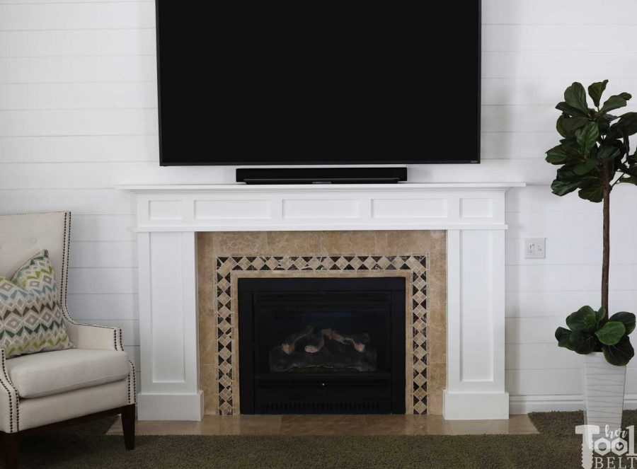 white craftsman mantel and shiplap wall