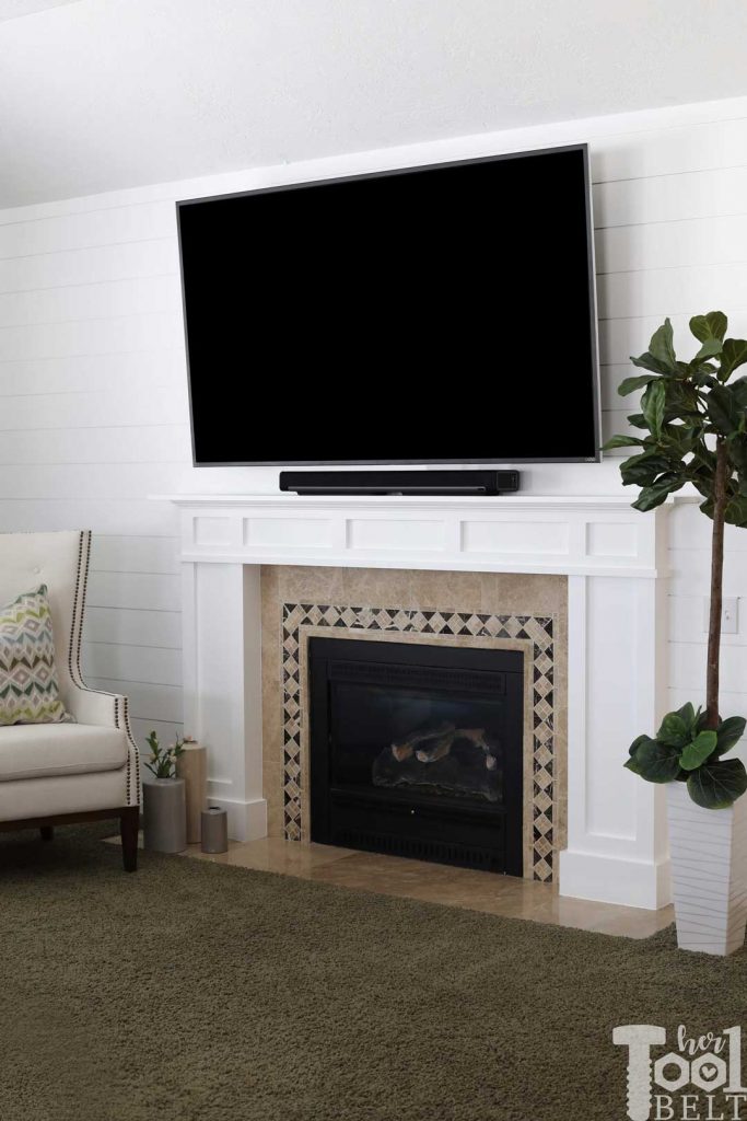 DIY modern white craftsman fireplace mantle and shiplap wall.