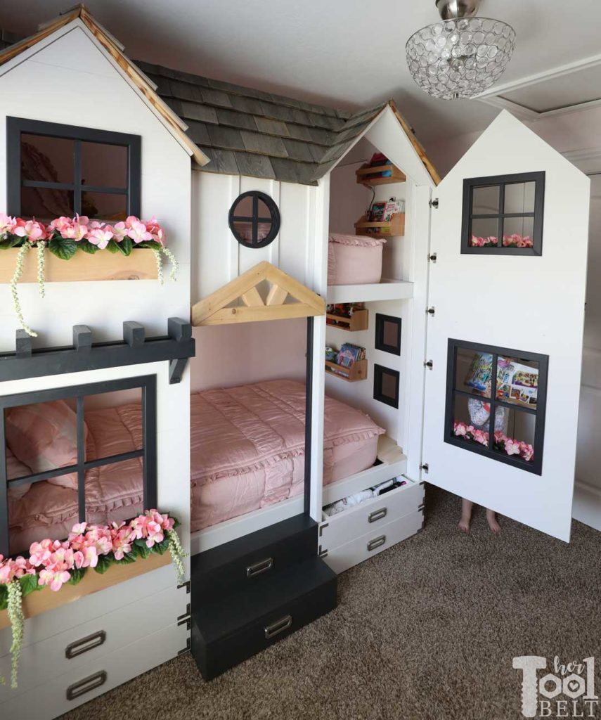 Build a super fun twin bunk bed that looks like a tiny house. Easy access to bedding with front panels on hinges. Free plans on hertoolbelt.com