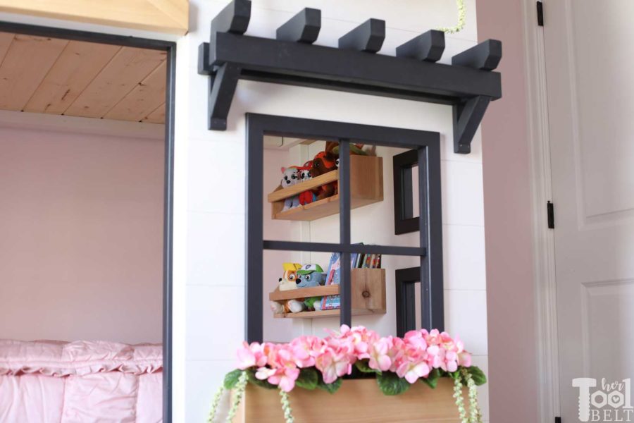 Build a super fun twin bunk bed that looks like a tiny house. Free plans on hertoolbelt.com. Books for story time.